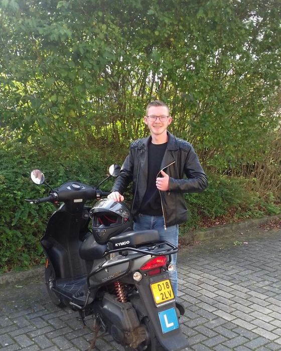 Patrick Hebels uit Meppel bij een scooter na zijn bromfietsexamen